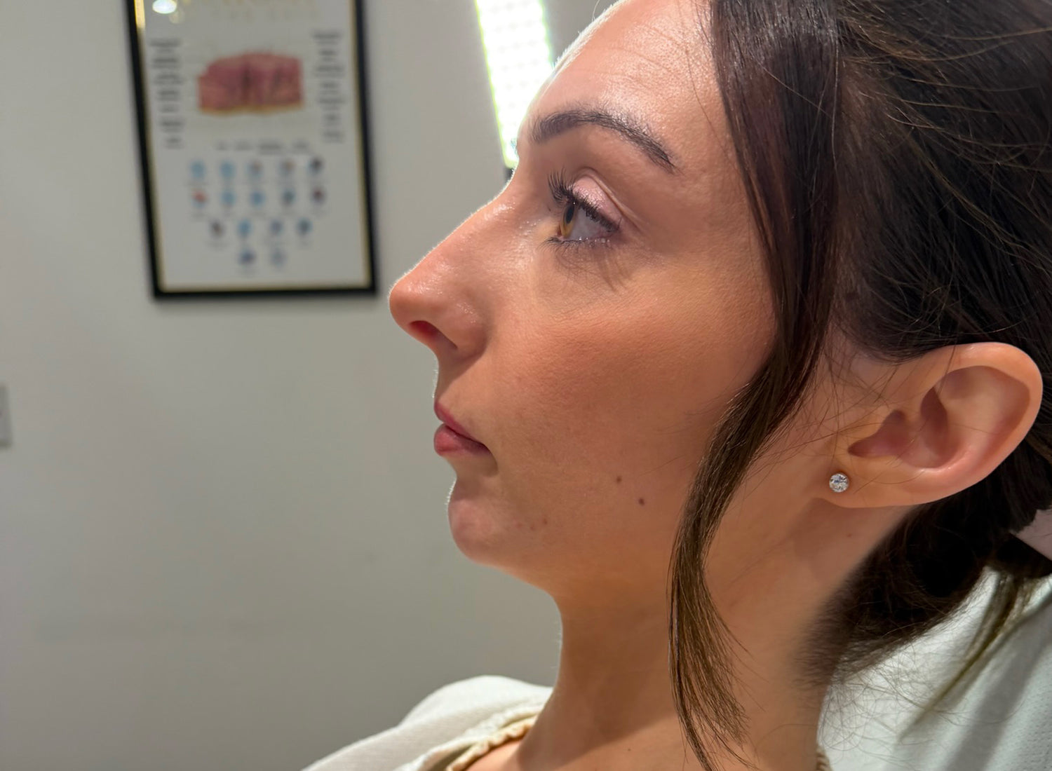 Close-up of a woman's profile with a calendar in the background