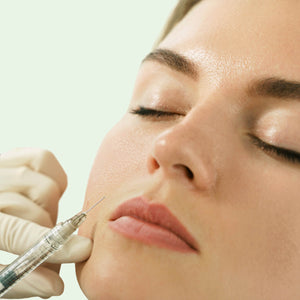 Close-up of a person receiving a facial injection with a syringe - Ageless Medical Clinic