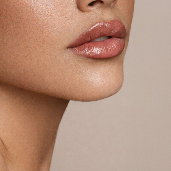 Close-up of a person's lips with a neutral background - Ageless Medical Clinic