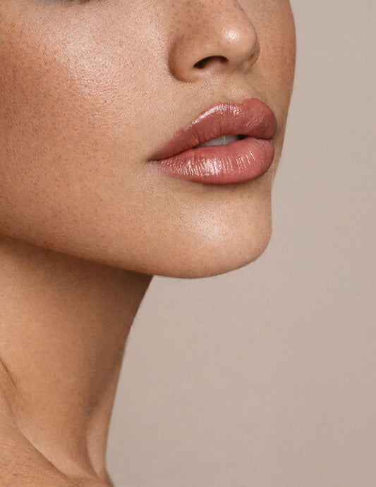 Close-up of a person's lips with a neutral background - Ageless Medical Clinic