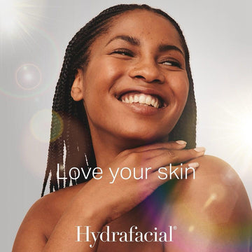 Woman with braided hair smiling, with 'Hydrafacial' branding and text 'Love your skin'.