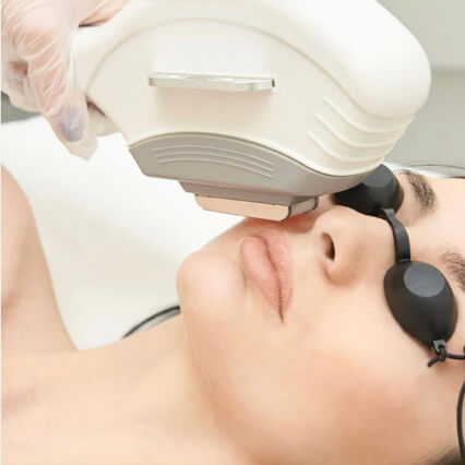 Person receiving a facial treatment with a device on their face