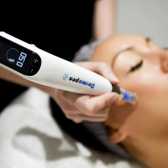 Woman receiving a facial treatment with a digital device.