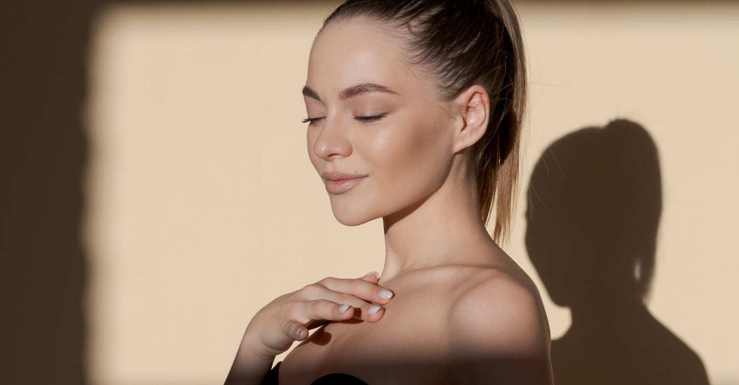 Woman with a soft shadow on a beige background - Ageless Medical Clinic