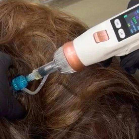 Person receiving a hair treatment with a device on a salon chair.