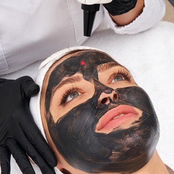 Person receiving a blackhead removal treatment with a device on their face.